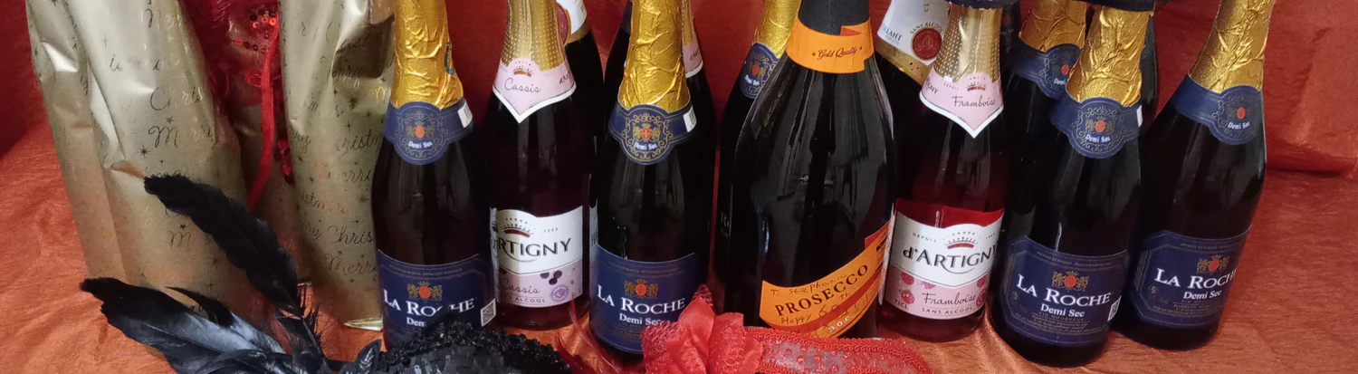 row of wine and champagne bottles on a table