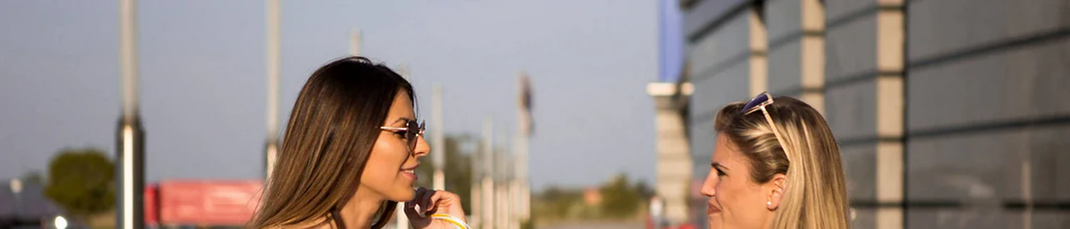 two ladies facing each other engaged in converstaion